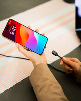 Connect Pro Magnetic Cable Set — magnetic tip being connected to an iPhone held over a desk — Chargeasap