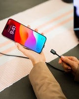 Connect Pro Magnetic Cable Set — magnetic tip being connected to an iPhone held over a desk — Chargeasap