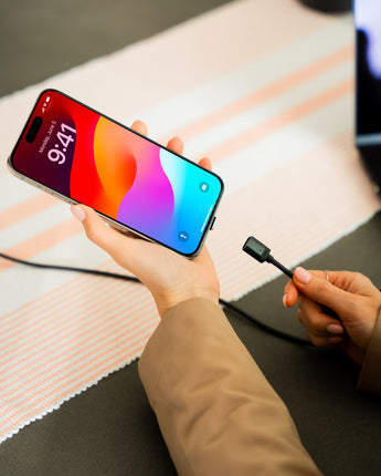 Connect Pro Magnetic Cable Set — magnetic tip being connected to an iPhone held over a desk — Chargeasap