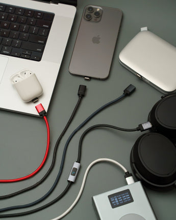 Connect Pro Magnetic Cable Set — desk flat lay with a laptop, phone, earbuds and power bank on charge — Chargeasap