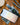Image of Graphene Powerbank, Flash Pro Plus, with 25000mAh large battery capacity, OLED display, USB-C 100W fast charging. An iPhone 14 is being charged on the MagSafe compatible wireless charging up to 15W. An Apple Watch is being charged on the separate Apple Watch charging pad supporting up to 5W. Perfect for Apple users on the go.