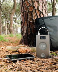 Thumbnail for Image of Graphene Powerbank, Flash Pro Plus charging iPhone in the forest, with 25000mAh large battery capacity, OLED display, USB-C 100W fast charging. An iPhone 14 is being charged on the MagSafe compatible wireless charging up to 15W. An Apple Watch is being charged on the separate Apple Watch charging pad supporting up to 5W. Perfect for Apple users on the go. 