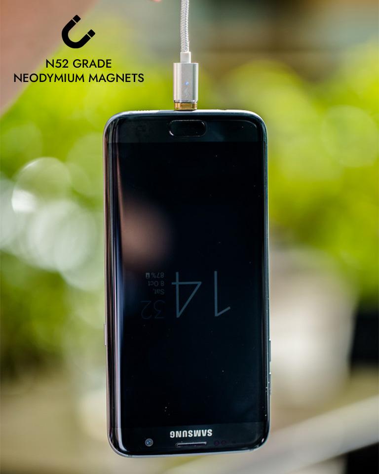 Phone being dangled and held up by our strong universal magnetic USB A cable that's compatible with all phones including Apple (Lightning) and Android (Micro USB & USB C).