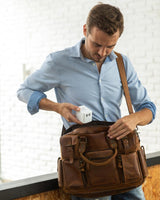 white universal travel adapter with GaN technology being put into a bag