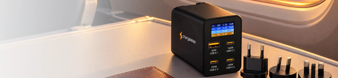 Zeus 280W charger with UK, EU and AU adapters on a plane tray table
