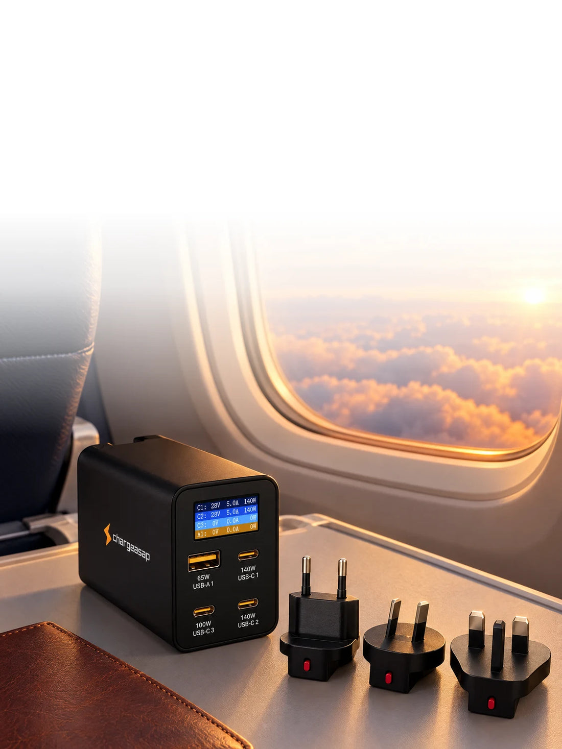 Zeus 280W charger with travel plugs on an airplane tray table