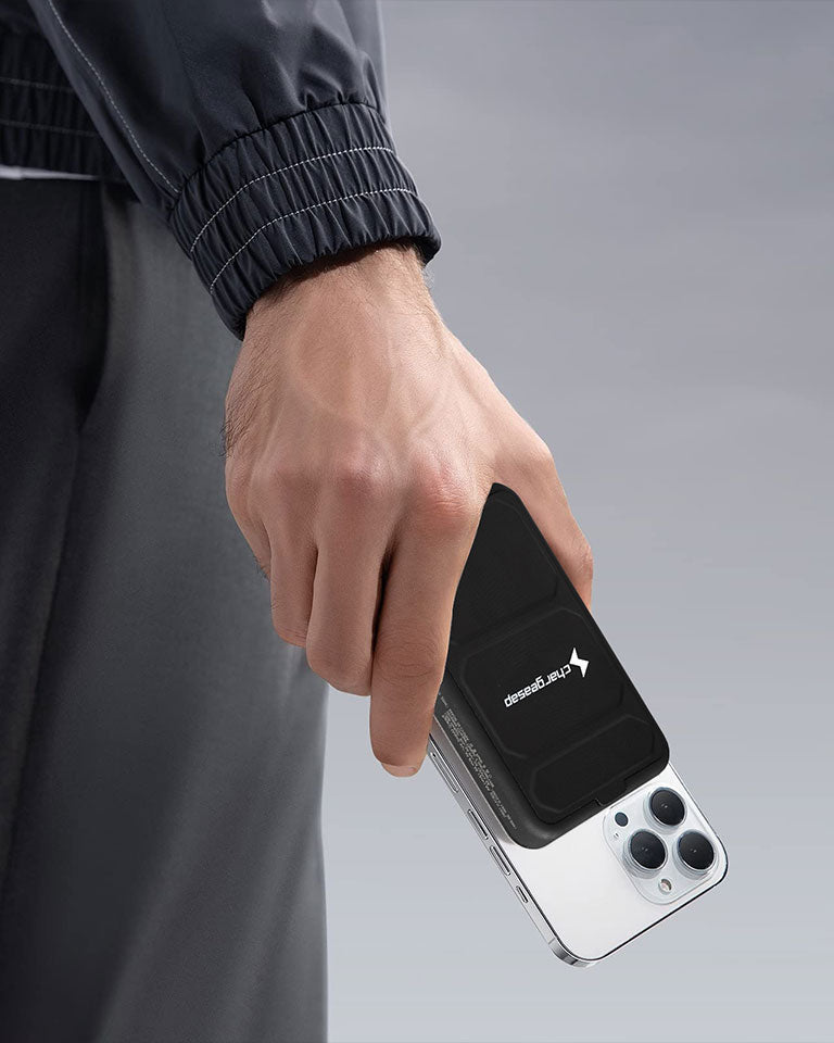 person holding iphone with magnetic powerbank
