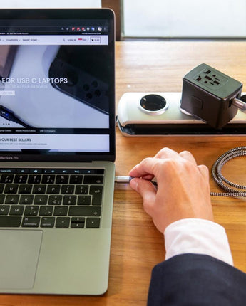 white universal travel adapter with GaN technology charging macbook